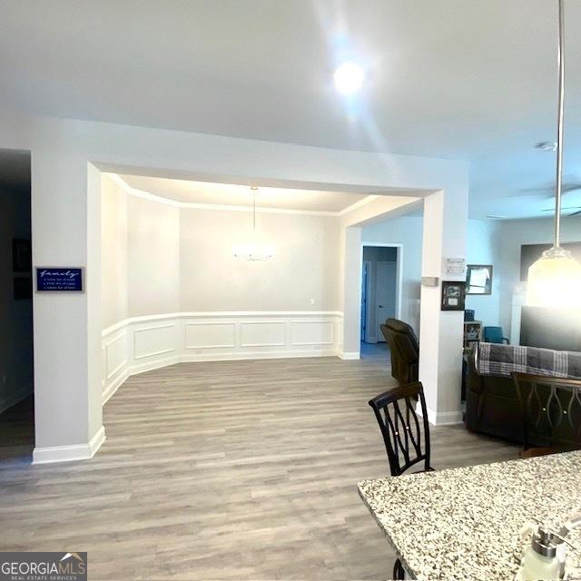 104 Eagle Heights Dr, Maysville, GA 30558 - dining room with a decorative wall, a wainscoted wall, crown molding, and light wood-type flooring