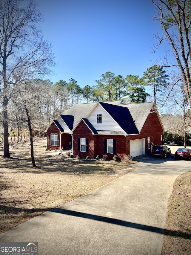 view of front of property with a garage, concrete driveway, and brick siding