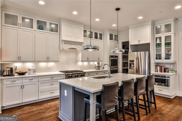 kitchen featuring white cabinetry, appliances with stainless steel finishes, dark wood-style flooring, and a sink