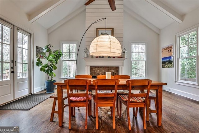 dining room with dark wood-style floors, french doors, beamed ceiling, and a wealth of natural light