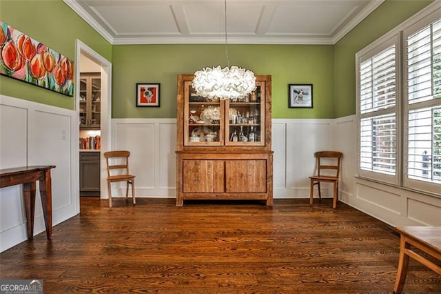 dining room with a wainscoted wall, a decorative wall, and dark wood-style flooring