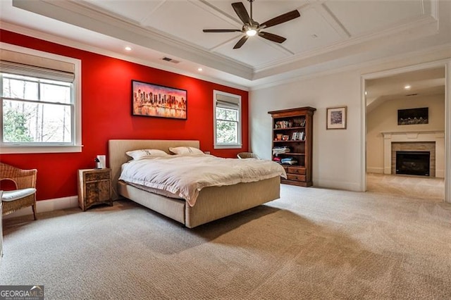 carpeted bedroom featuring a fireplace, crown molding, visible vents, ceiling fan, and baseboards