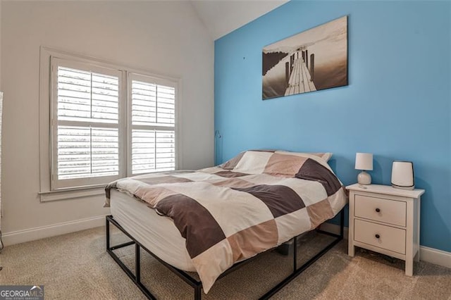 bedroom featuring baseboards, vaulted ceiling, and carpet flooring