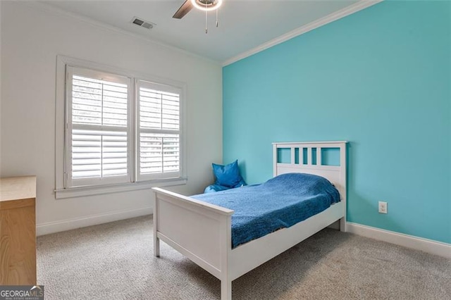 bedroom featuring carpet, visible vents, crown molding, and baseboards