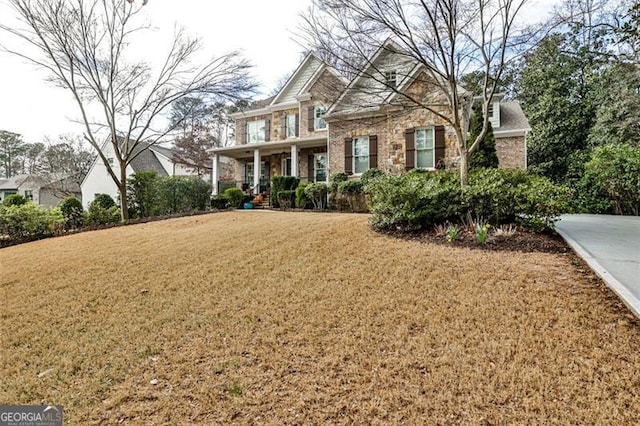 craftsman-style house with a front lawn and brick siding