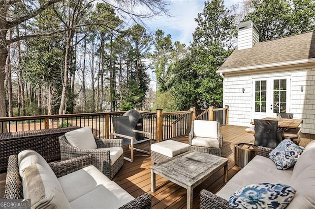 wooden terrace with french doors and outdoor lounge area