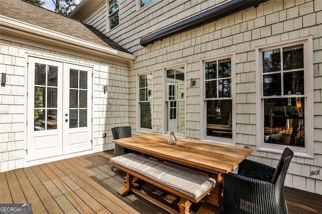 deck featuring outdoor dining area and french doors