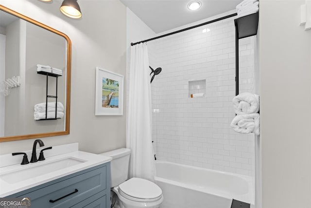 bathroom with shower / bath combo, vanity, and toilet