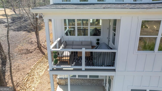 entrance to property featuring a shingled roof and board and batten siding