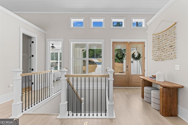 entryway with ornamental molding, french doors, and wood finished floors