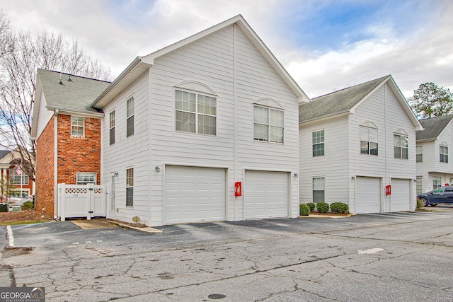 exterior space with brick siding and an attached garage