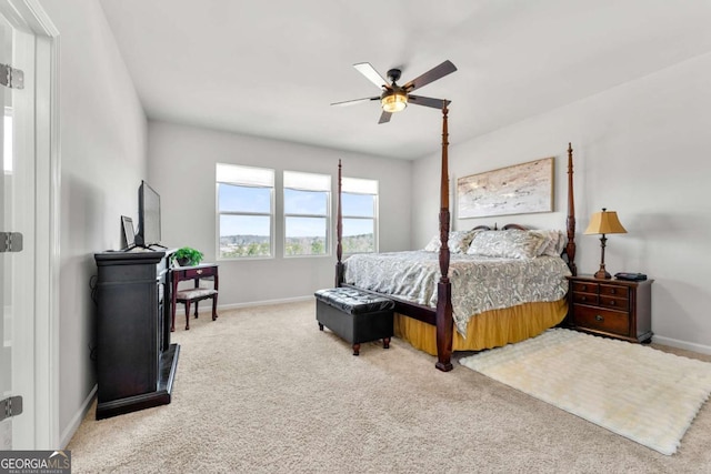 carpeted bedroom with a ceiling fan and baseboards