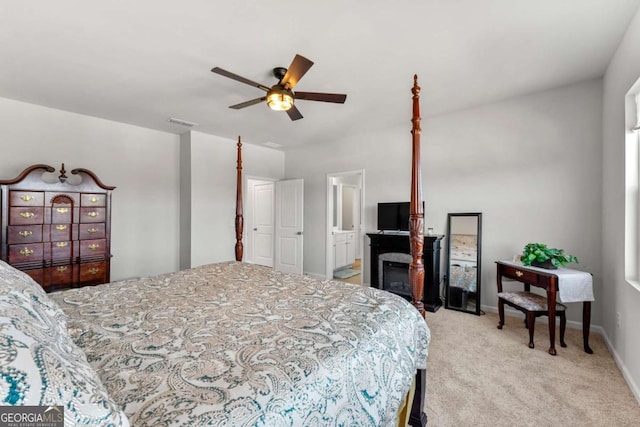 bedroom with ceiling fan, connected bathroom, light carpet, visible vents, and baseboards