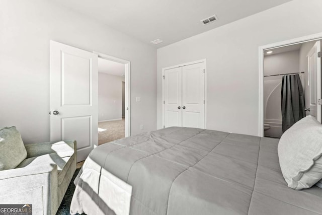 carpeted bedroom featuring a closet, connected bathroom, and visible vents