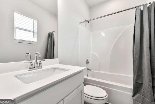 bathroom featuring toilet, shower / tub combo with curtain, and vanity