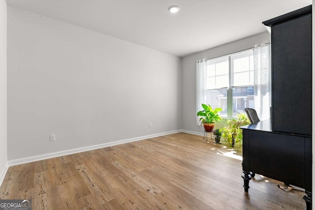 living area featuring wood finished floors and baseboards