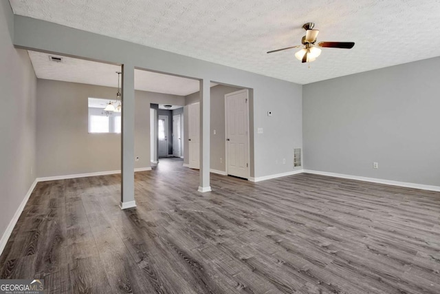 interior space featuring dark wood finished floors, visible vents, and baseboards