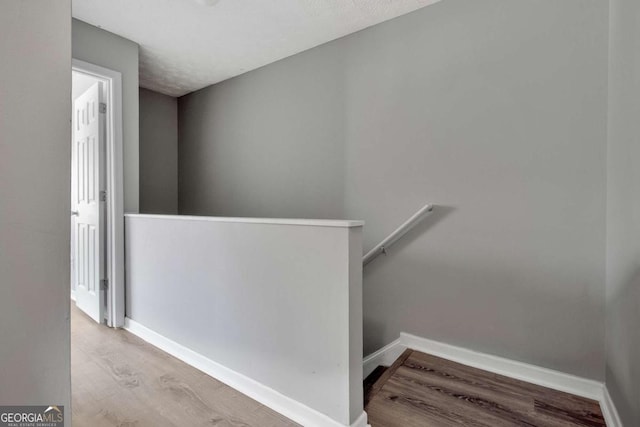 stairs with baseboards and wood finished floors