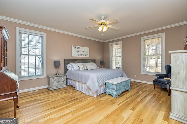 bedroom featuring light wood-type flooring, multiple windows, crown molding, and baseboards