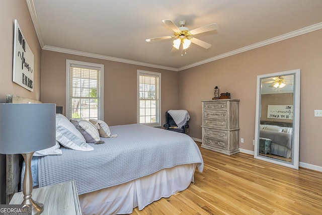 bedroom featuring ornamental molding, baseboards, ceiling fan, and light wood finished floors