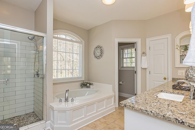 bathroom with a shower stall, a bath, and tile patterned floors