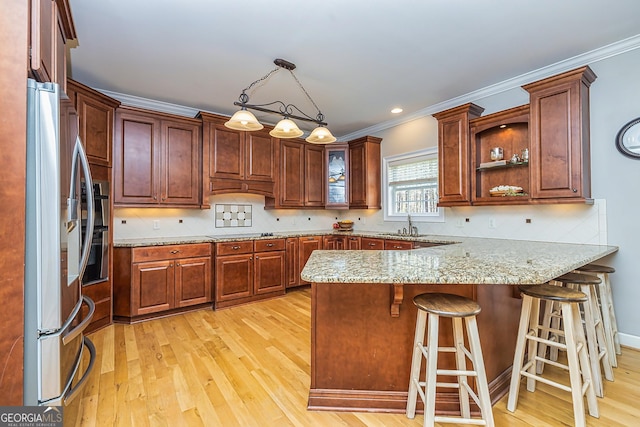 kitchen featuring black electric cooktop, a peninsula, stainless steel fridge with ice dispenser, decorative backsplash, and light wood finished floors