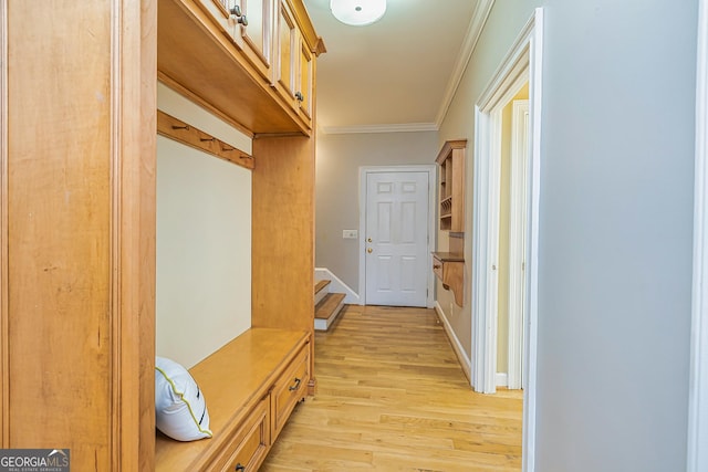 mudroom with ornamental molding, baseboards, and light wood finished floors