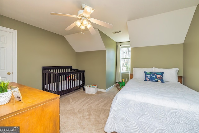 bedroom featuring visible vents, a ceiling fan, carpet flooring, vaulted ceiling, and baseboards