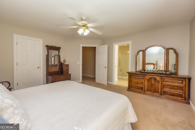 bedroom with carpet, baseboards, ceiling fan, and ensuite bathroom