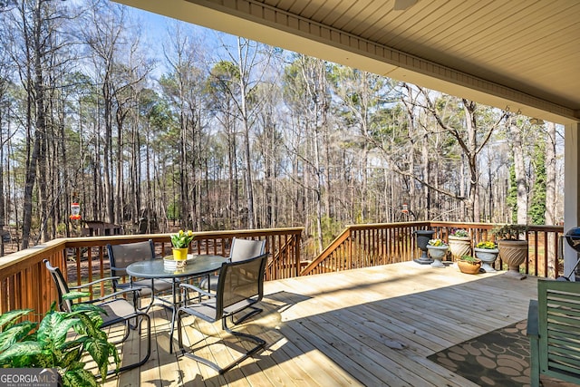 wooden terrace with outdoor dining space