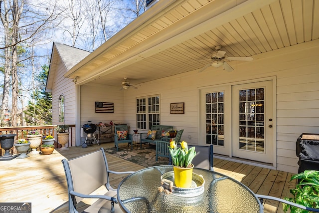 wooden deck featuring ceiling fan and outdoor dining space