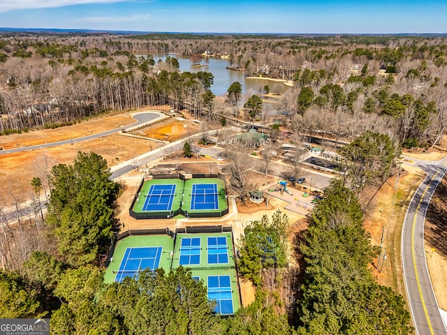 drone / aerial view with a water view and a forest view