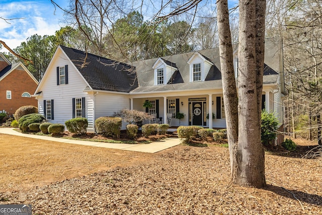 cape cod home featuring a porch