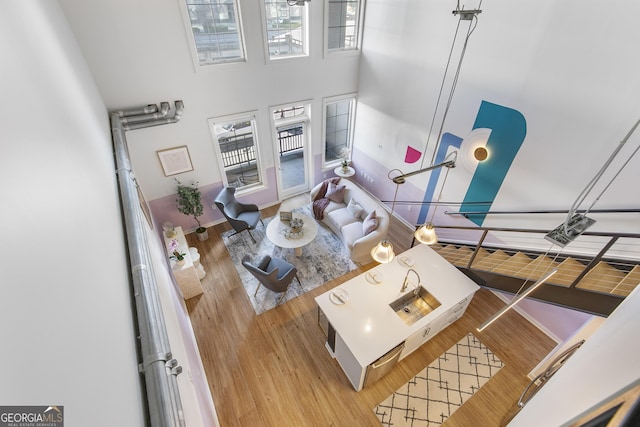 living area with a high ceiling and wood finished floors