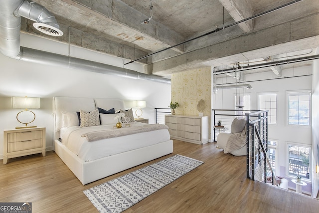 bedroom with visible vents and wood finished floors