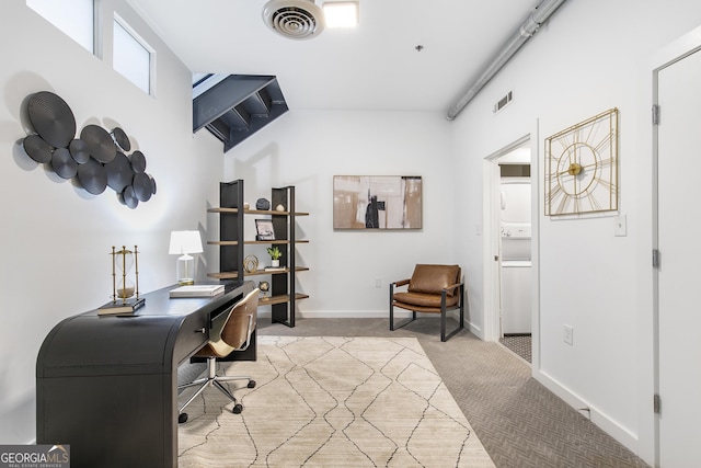 office area featuring baseboards, visible vents, and light colored carpet