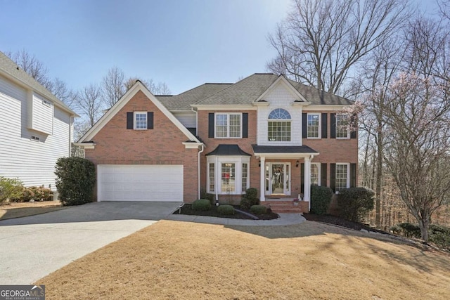 view of front of home with a garage, concrete driveway, and brick siding