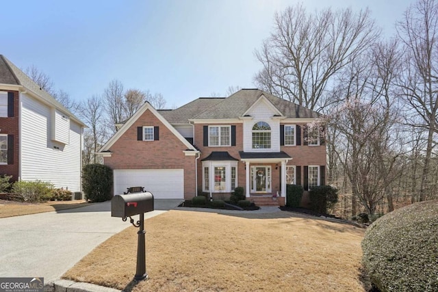 view of front facade with brick siding, driveway, and an attached garage