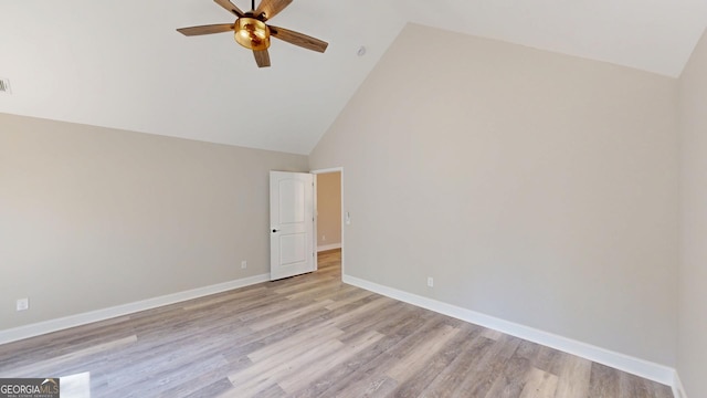 empty room featuring high vaulted ceiling, light wood-type flooring, a ceiling fan, and baseboards