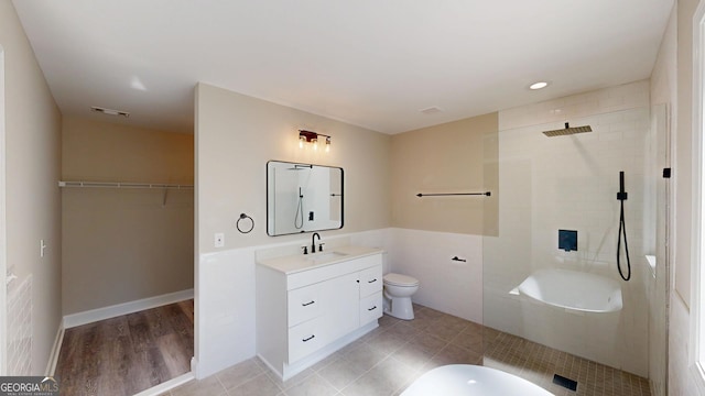 full bath featuring toilet, visible vents, walk in shower, and vanity