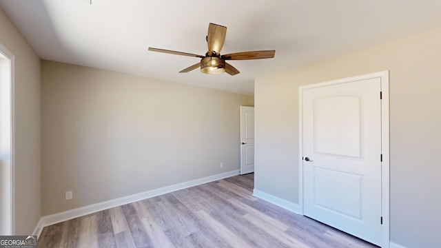 unfurnished bedroom featuring a ceiling fan, light wood finished floors, and baseboards