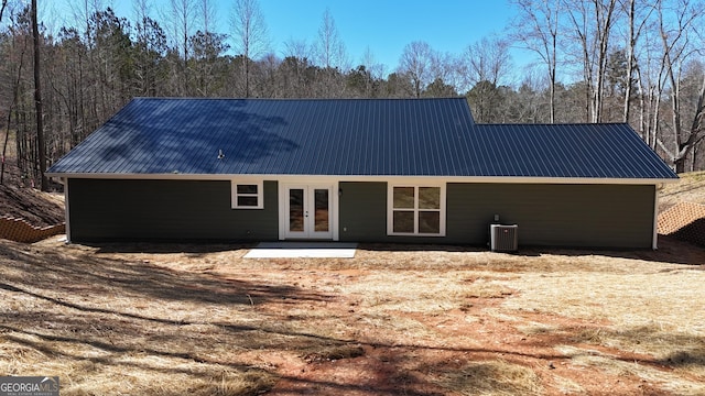 view of front of house featuring metal roof, french doors, and cooling unit