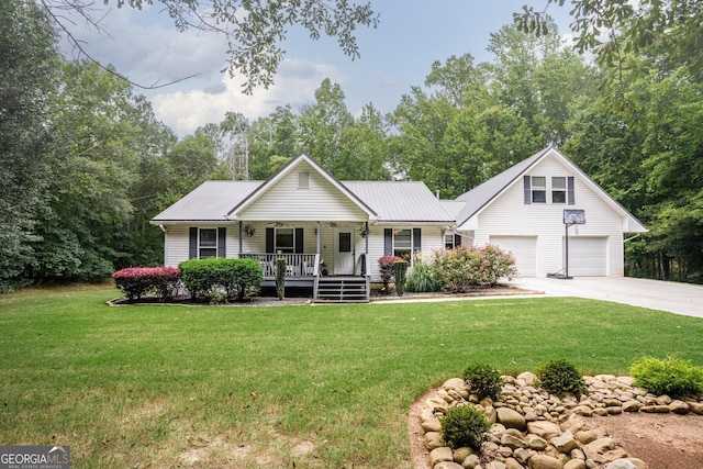 ranch-style house with covered porch, driveway, metal roof, and a front yard