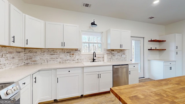 kitchen with tasteful backsplash, white electric range, visible vents, a sink, and dishwasher