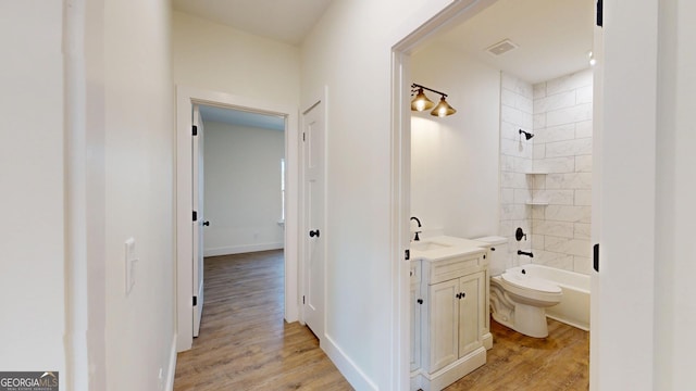 bathroom with visible vents, vanity, toilet, and wood finished floors