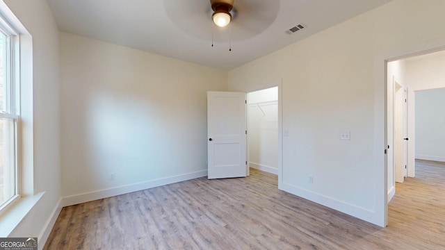 unfurnished bedroom with baseboards, visible vents, and light wood finished floors