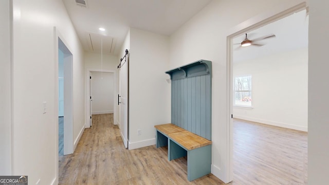 mudroom featuring visible vents, attic access, a ceiling fan, light wood-type flooring, and baseboards