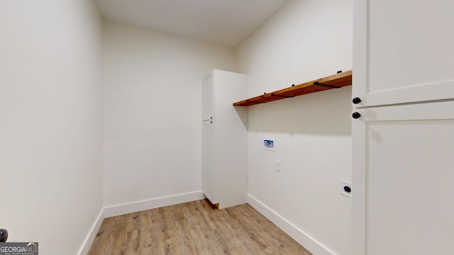 laundry area with hookup for a washing machine, laundry area, light wood-style floors, and baseboards