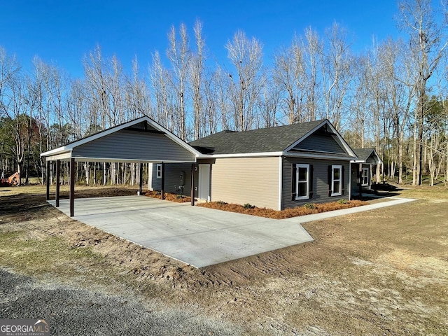 single story home with concrete driveway