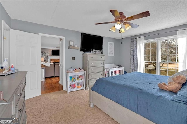 bedroom featuring light colored carpet and ceiling fan